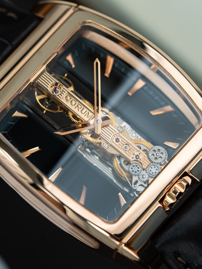 A detailed close-up of a luxury gold wristwatch showcasing intricate mechanical elements.